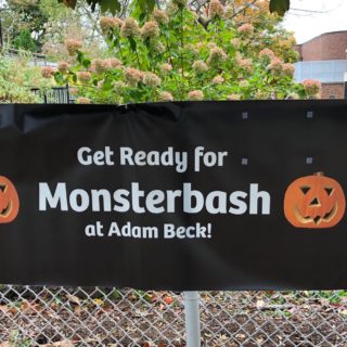 Photo of a Monsterbash banner on the school fence reading Get Ready for Monsterbash at Adam Beck