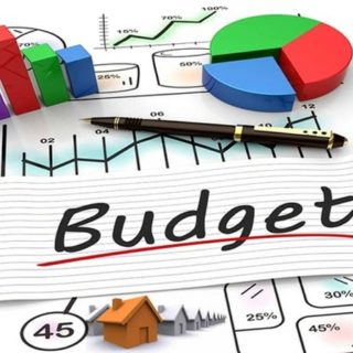The word budget in black on a white background surrounded by graphs and charts