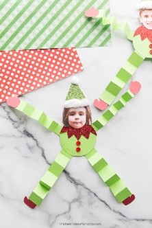 Photo of a child's face on an elf's body crafted from paper and more